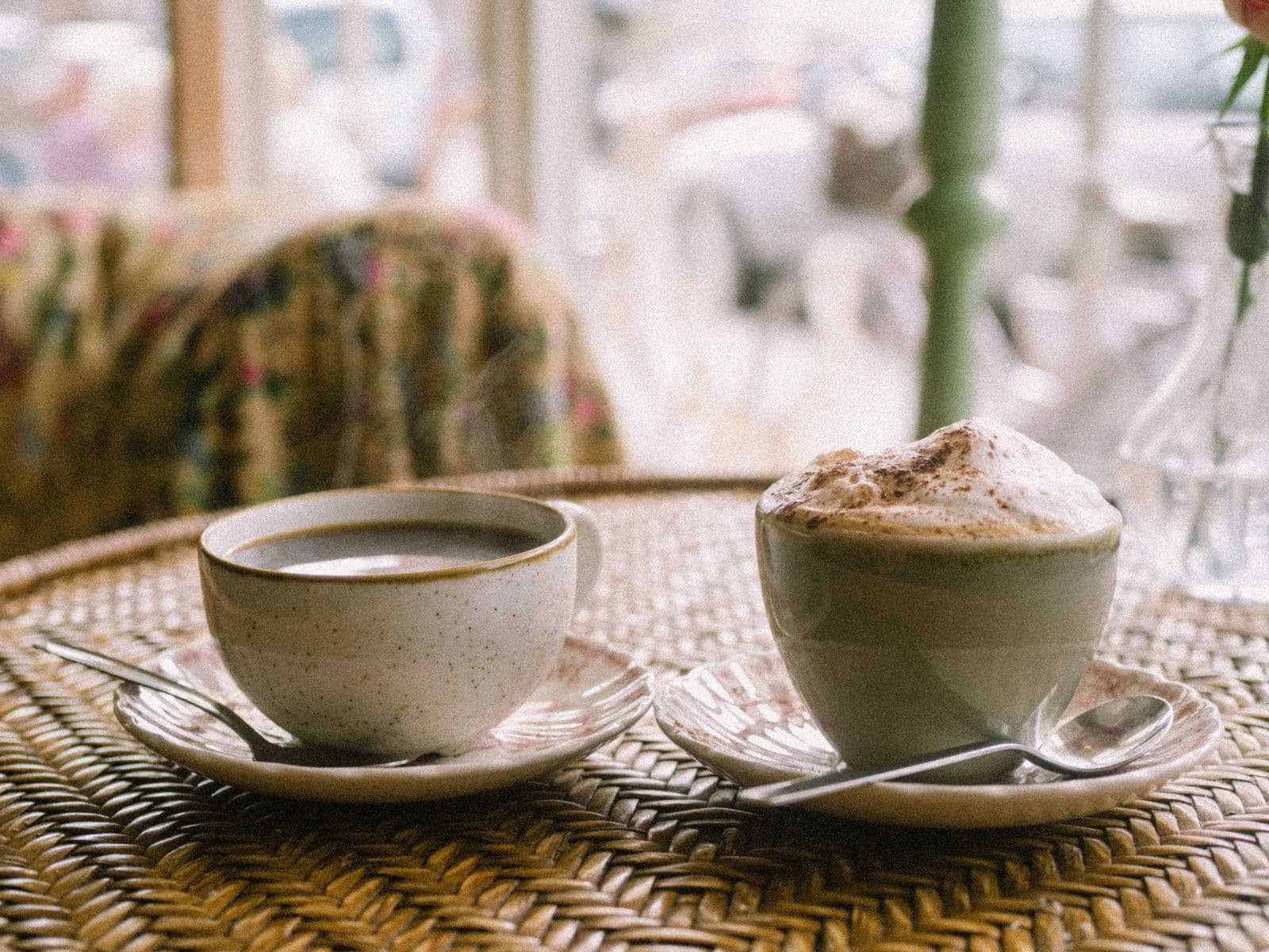 Two coffee cups on a café table
